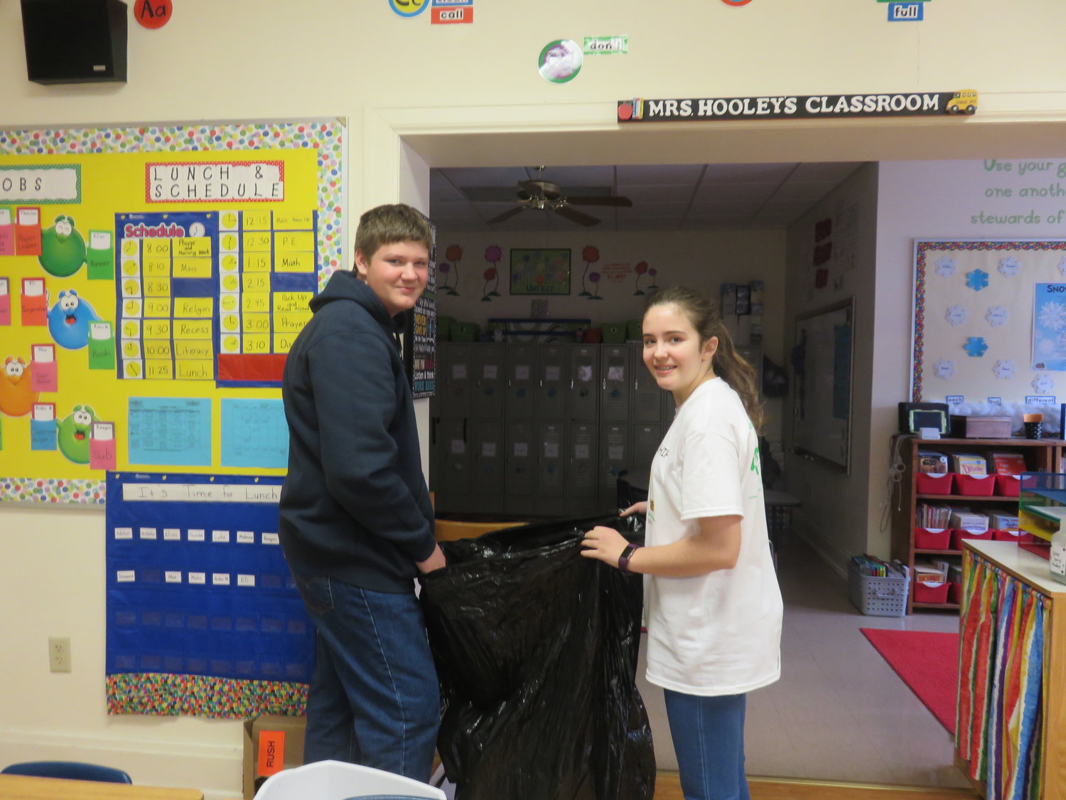 Eight-graders help with Holy Family School's recycling project.